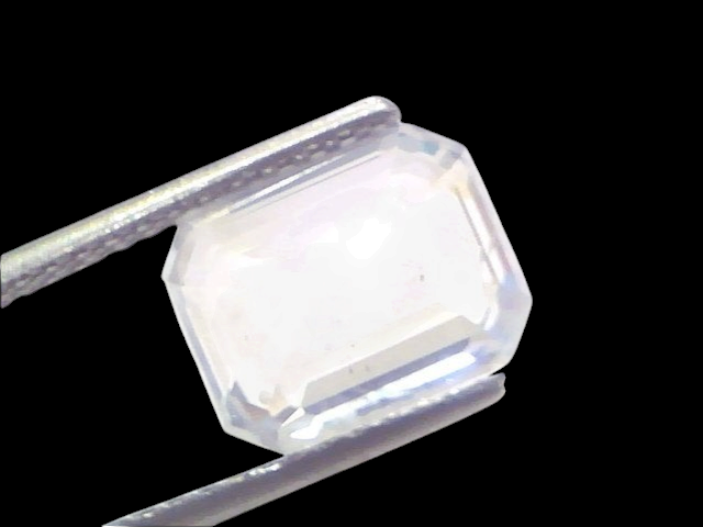 5.70 Ct Gii Certified Unheated Untreated Natural Ceylon White Sapphire, displayed in tweezers, showcasing its clarity and cut
