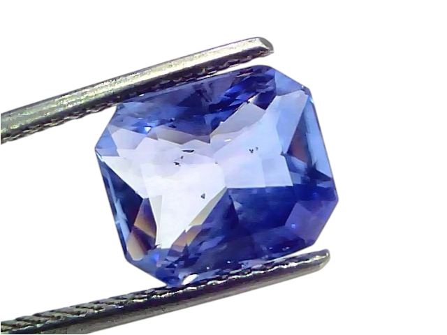 5.16 carat IGI certified unheated natural Ceylon blue sapphire, octagonal cut, held by tweezers against a white background.