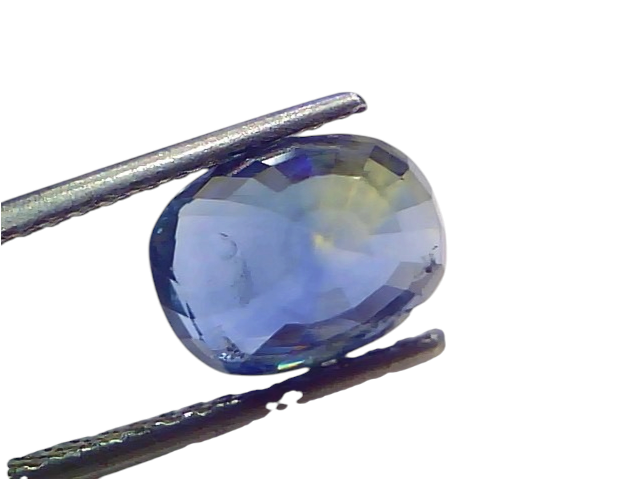 5.07 carat unheated natural Ceylon blue sapphire held by tweezers, showcasing its deep blue color and clarity.