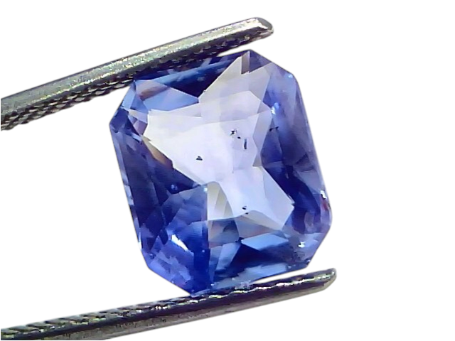 5.16 carat IGI certified unheated natural Ceylon blue sapphire, octagonal cut, held by tweezers against a white background.