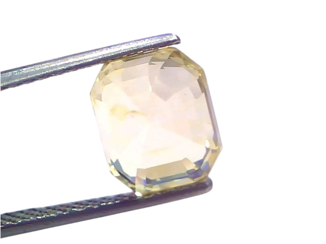 6.29 Ct IGI Certified Unheated Natural Ceylon Yellow Sapphire Pukhraj, octagonal cut, displayed with tweezers against a light