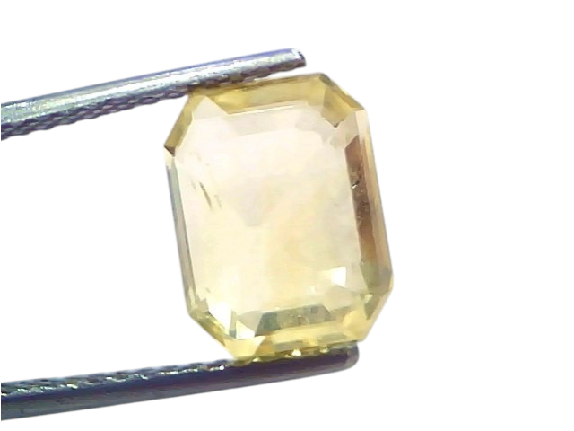 6.26 Ct IGI Certified Unheated Natural Ceylon Yellow Sapphire Pukhraj, octagonal cut, held with tweezers against a white back