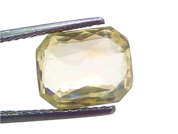 6.00 Ct IGI Certified Unheated Natural Ceylon Yellow Sapphire Pukhraj, octagonal cut, held with tweezers against a light back