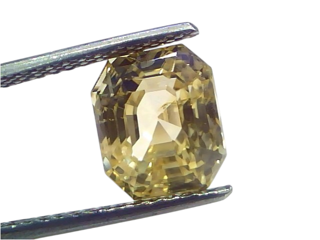 6.29 Ct IGI Certified Unheated Natural Ceylon Yellow Sapphire Pukhraj, octagonal cut with a golden hue, held by tweezers.