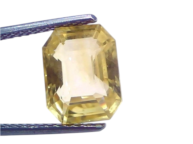 6.26 Ct IGI Certified Unheated Natural Ceylon Yellow Sapphire Pukhraj, octagonal cut, held by tweezers against a light backgr