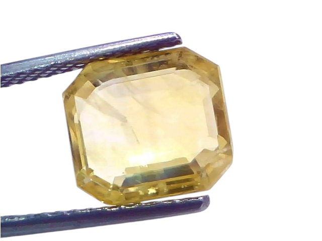 6.61 Ct IGI Certified Unheated Natural Ceylon Yellow Sapphire Pukhraj, octagonal cut, held with tweezers, showcasing its clar