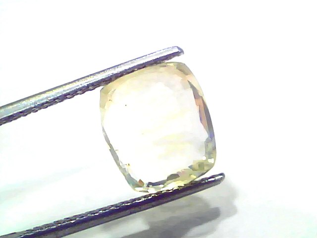 7.13 Carat Certified Ceylon Natural Yellow Sapphire Pukhraj, cushion-cut, held by tweezers against a white background.