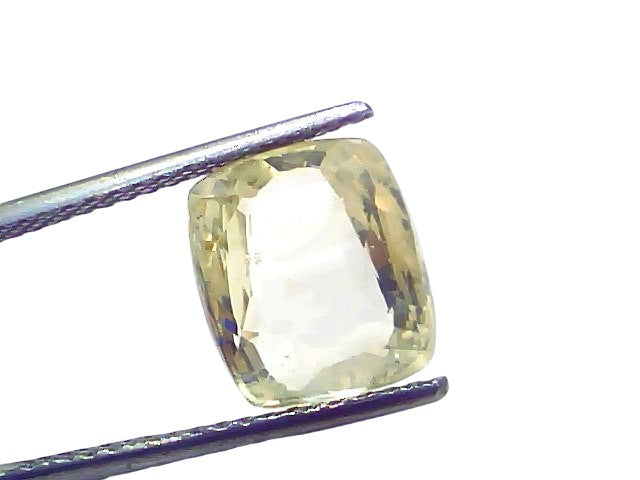 7.13 Carat Ceylon Natural Yellow Sapphire Pukhraj, cushion-cut gemstone held by tweezers, showcasing its clarity and color.