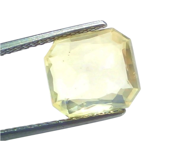 8.52 Ct IGI Certified Unheated Natural Ceylon Yellow Sapphire Pukhraj, octagonal cut, held with tweezers against a white back