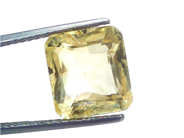 9.07 Ct IGI Certified Unheated Natural Ceylon Yellow Sapphire Pukhraj, rectangular cut, held with tweezers, light yellow hue.